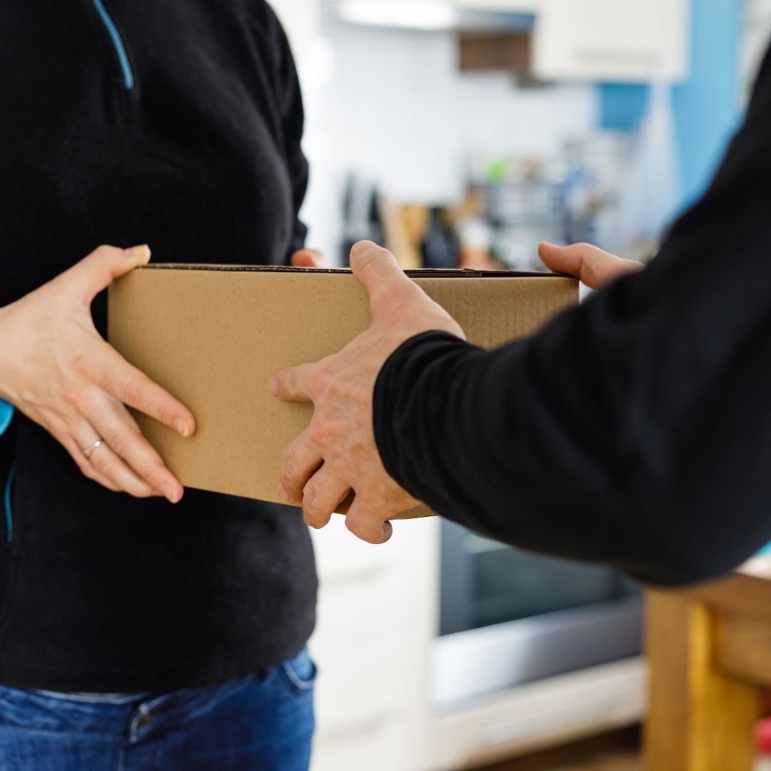 Man giving Danes coffee box to staff for delivery